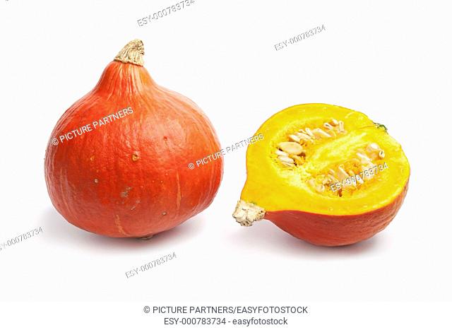 Whole and partial orange Hokkaido pumpkin on white background