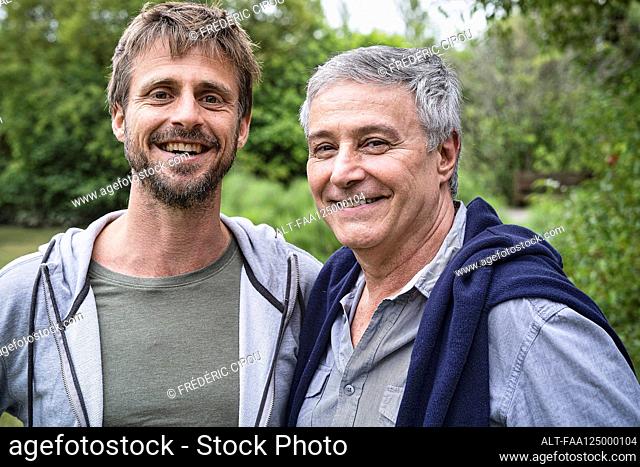 Father and son standing in garden
