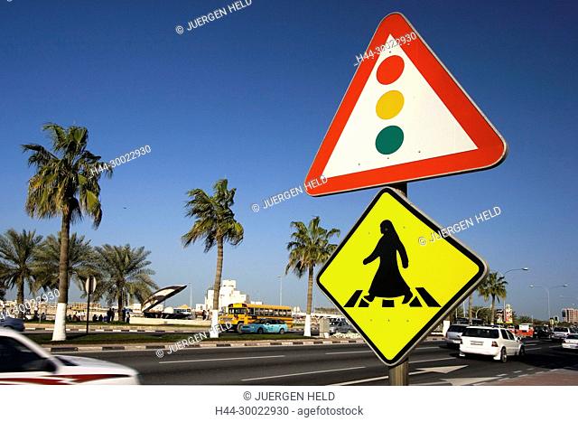 Qatar Doha arabian sign for crosswalk at the al corniche street , in the background Museum of islamic art and the oyster fountain with pearl along the shore of...