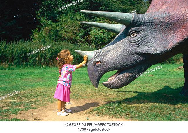Child in dinosaur park