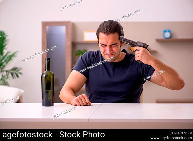 Young alcoholic committing suicide at home