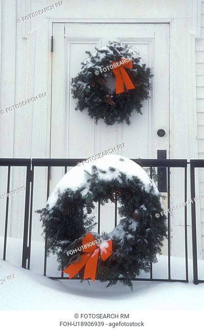 Christmas wreath, wreaths, decoration, ribbon, Christmas, holiday, snow, winter, Two snow covered green wreaths with red bows decorate the outside of a the...