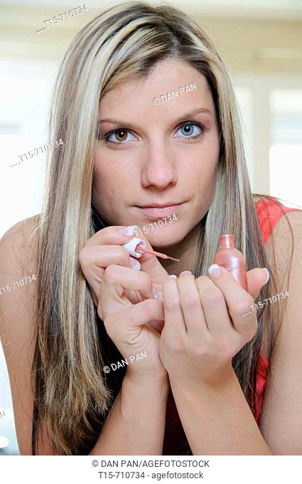 woman painting her finger nails