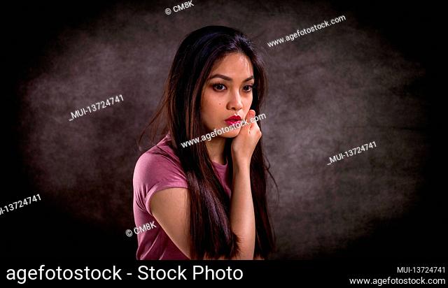 Pretty Asian woman - portrait shot against grey background - studio photography