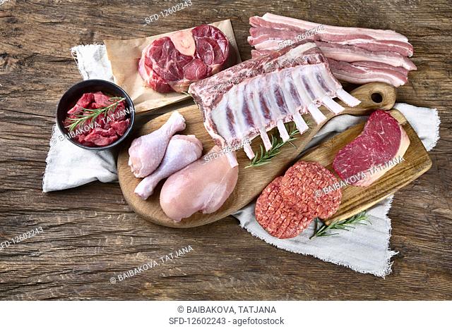 Various types of meat on wooden table