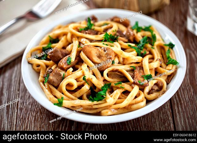 Tagliatelle with mushrooms on a plate. High quality photo