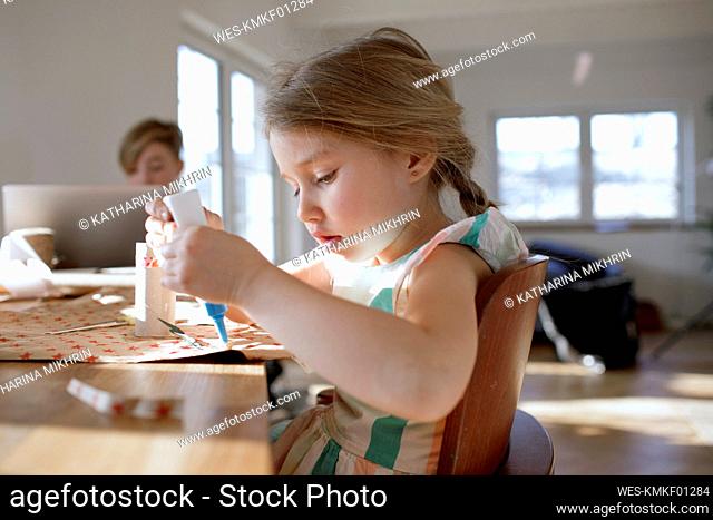 Portrait of little girl tinkering at home