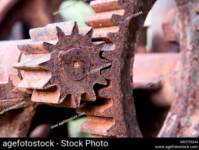 Details of a parts the moving parts of a rusty machine mechanical gear