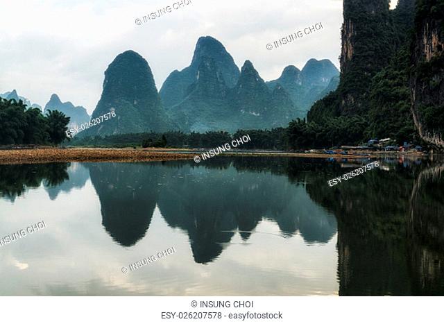 The morning sunrise view over li river with clouds and fogs surrounding the karst mountain tops. Xingping, Guangxi, China
