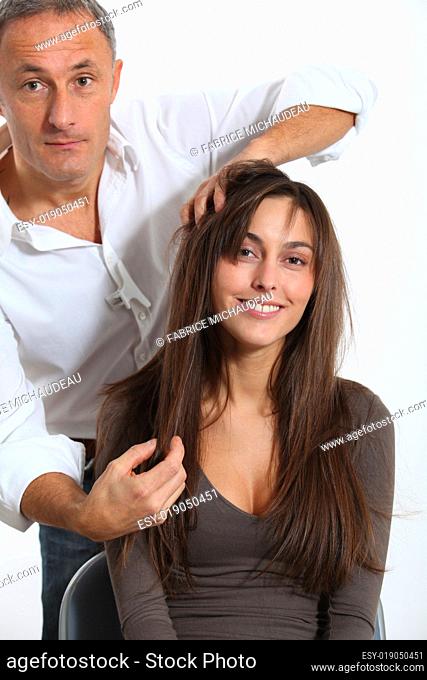 Hairdresser looking for woman's new haircut