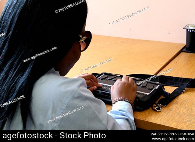 PRODUCTION - 23 November 2021, South Africa, Kapstadt: Blind student Gadija Gonsalwes (18) reads with an e-Braille PC at the Athlone School for the Blind near...