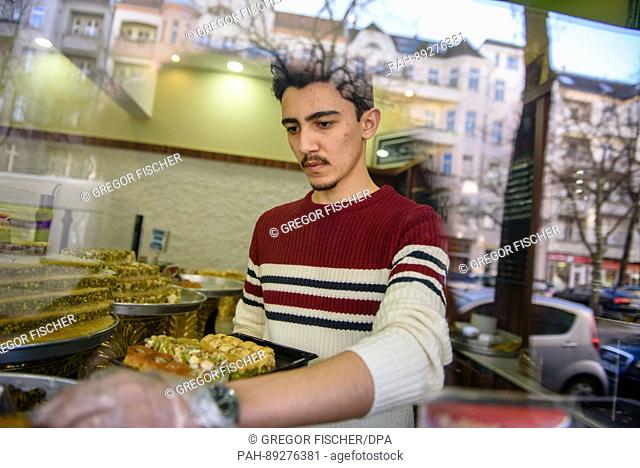 Sulaiman al-Sakka, employee and son of the family, puts together a present box with sweets at the confectionary Damaskus in Berlin, Germany, 15 March 2017