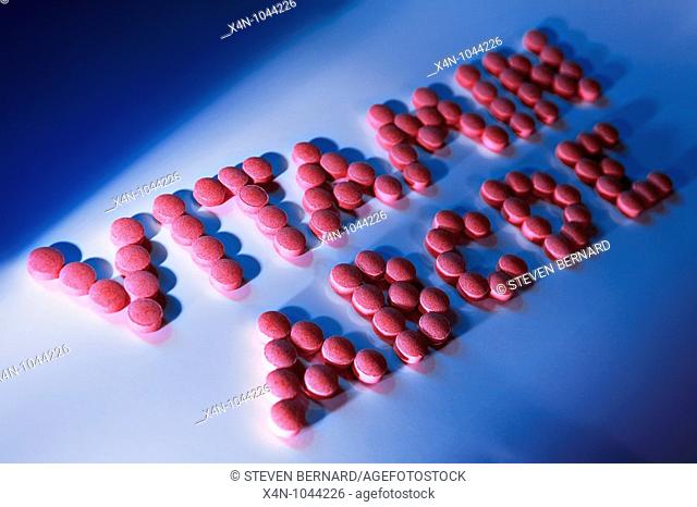 Vitamin pills spelling out the word vitamin and abcde