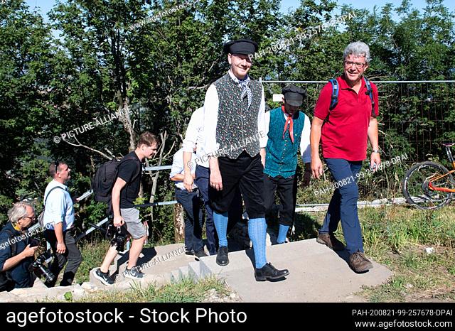 21 August 2020, Saxony, Großschönau: Michael Kretschmer (CDU, M), Prime Minister of Saxony, walks to the summit of the Lausche in traditional costume alongside...