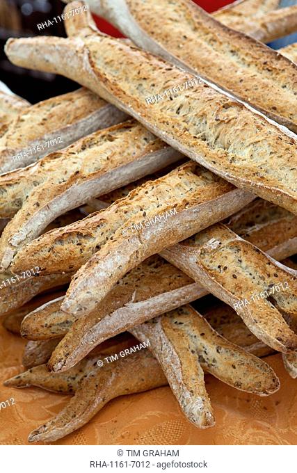 Freshly-baked multigrain 5 cereals French baguette bread on sale at food market at La Reole in Bordeaux region of France