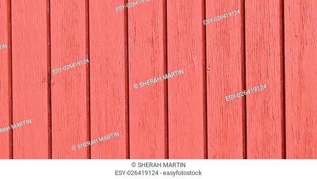 Old red paint on wooden slats, in widescreen size