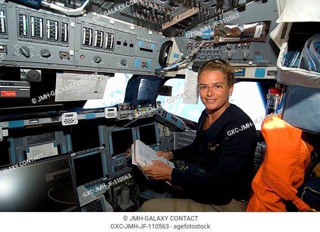 Astronaut Julie Payette, STS-127 mission specialist, temporarily occupies the pilot's station on the forward flight deck of the Space Shuttle Endeavour on...