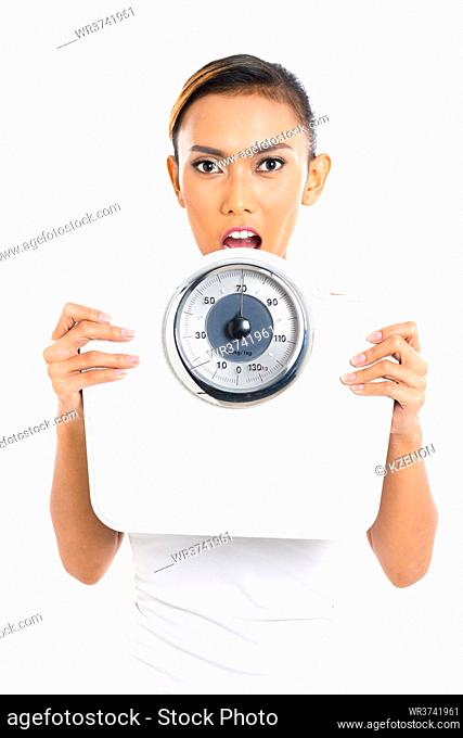 Asian woman with weight scale loosing weight