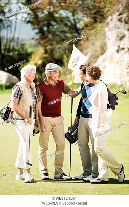 Italy, Kastelruth, Golfers talking on golf course