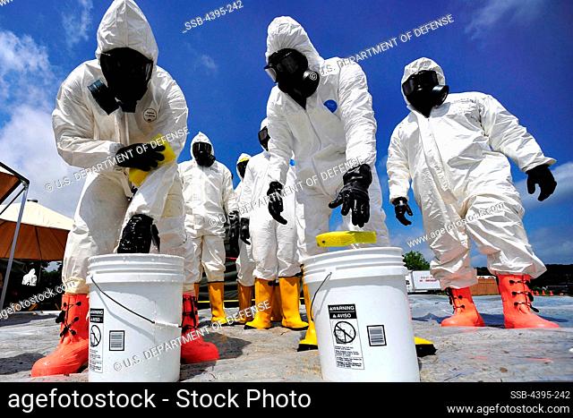 U.S. Army Soldiers from the 457th Chemical Battalion, sponge off their level A suits after a simulated nuclear detonation scenario at Muscatatuck Urban Training...