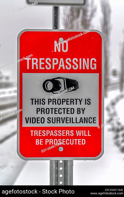 No Trespassing sign on a frosty winter day in Utah. A No Trespassing sign on a property protected by video surveillance in Daybreak, Utah