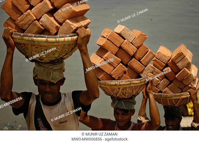 Workers are carrying brick at Kamrangir char Most of the workers earn 100/150 taka per day They work from early morning to evening without any rest Dhaka