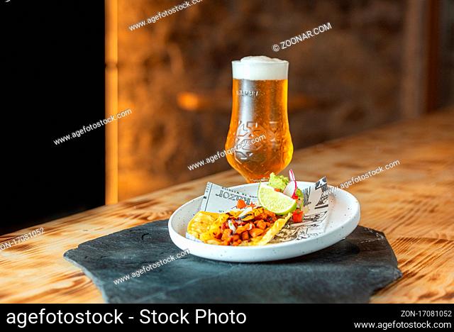 Arinsal, Andorra : 2021 April 29 : Beer accompanied by a taco al Pastor. Typical Mexican food
