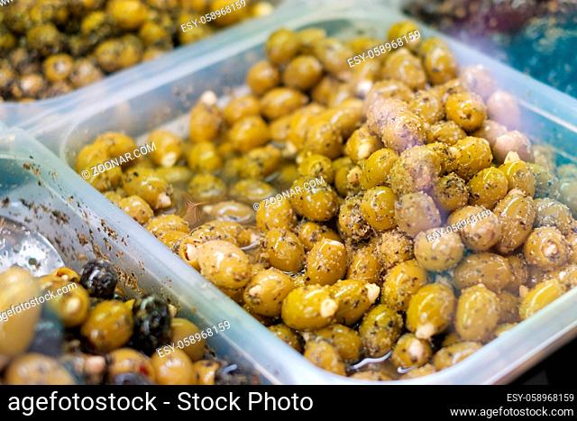 green olives at market - marinated olives stuffed with almonds -