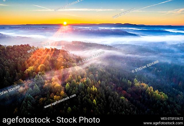 Germany, Baden-Wurttemberg, Drone view of Haselbachtal valley at foggy autumn sunrise