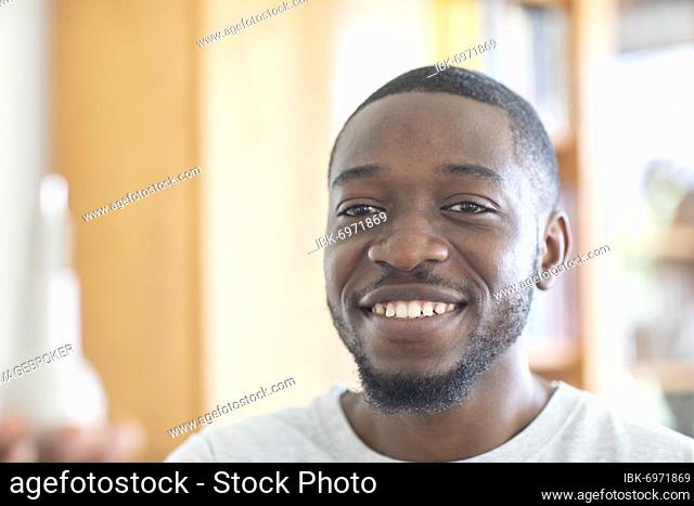 Young black man holding an idea in his hand in the office as an invention, vision, innovation, Freiburg, Baden-Württemberg, Germany, Europe