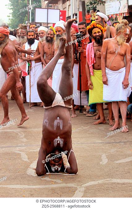 Sadhu performing yogic pose. Kumbh Mela, Nasik, Maharashtra, India
