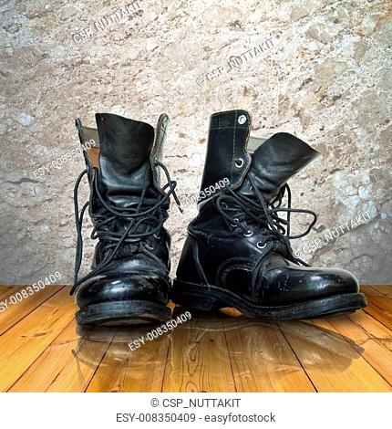 old black boot on wood floor