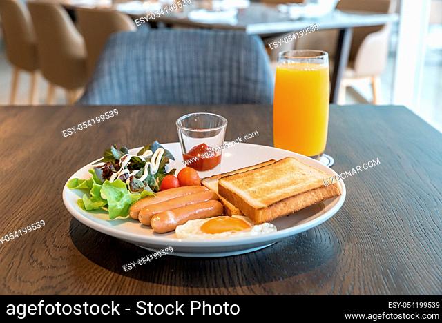 Breakfast sausage set with fried egg and orange juice