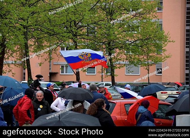 24 April 2022, Baden-Wuerttemberg, Lahr: People gather with Russian flags before the start of a pro-Russian motorcade through Lahr