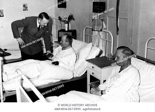 German Chancellor Adolf Hitler visits war wounded in a military hospital, during world war two. 1941
