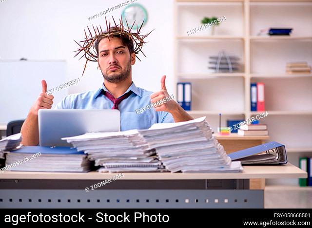 Young businessman employee wearing prickly wreath on head