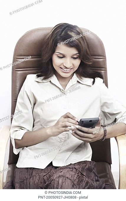 Close-up of a businesswoman using a personal data assistant