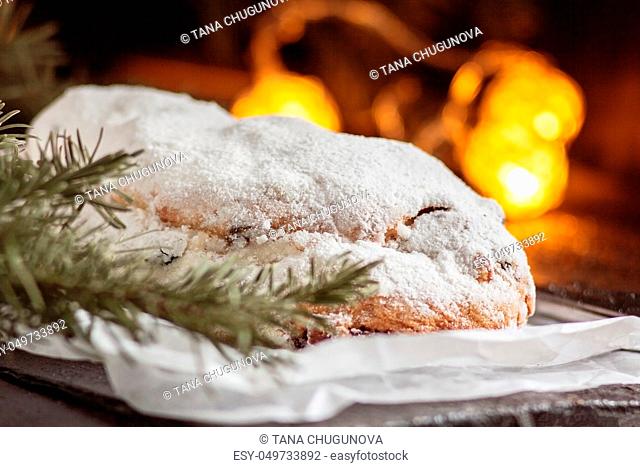 Dresden Stollen is a Traditional German Cake with raisins on a light knitted background.Gift for Christmas.Vintage style.Fruit cake for the Holiday