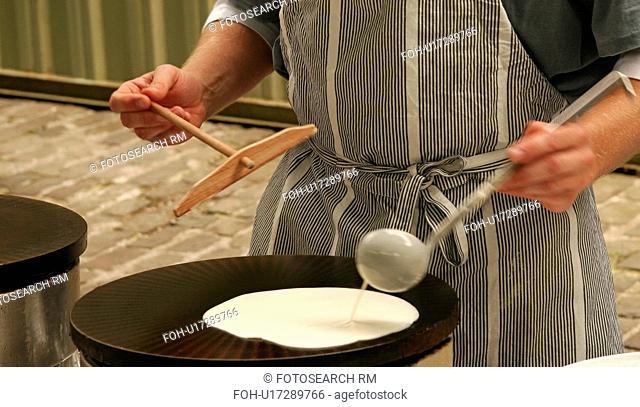 Pouring pancake mixture onto a hotplate