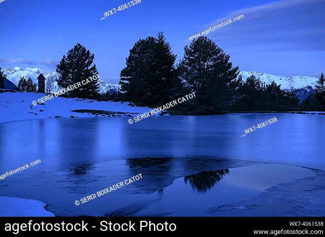 Bassa d'Arres lake, frozen, in a winter blue hour (Aran Valley, Catalonia, Spain, Pyrenees)