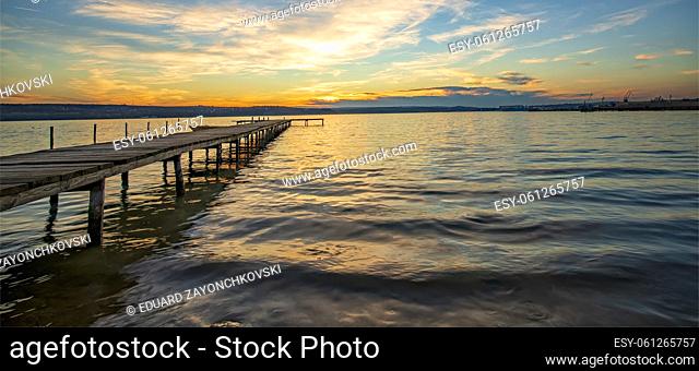 Panoramic view of stunning twilight at the shore with a wooden jetty