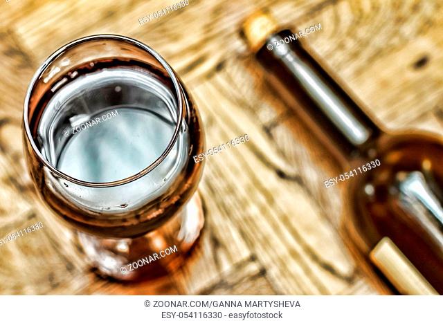 Valentine's Day. Date. Wine in a glass and bottle of wine on a wooden background. Romance