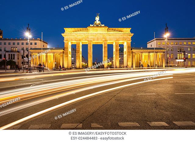 Berlin's Brandenburg Gate at twilight with speeding traffic light trails