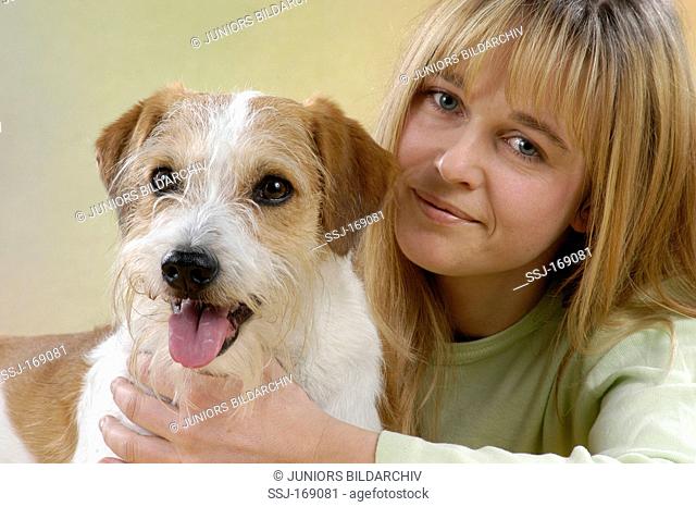 Young woman with mixed-breed dog, portrait