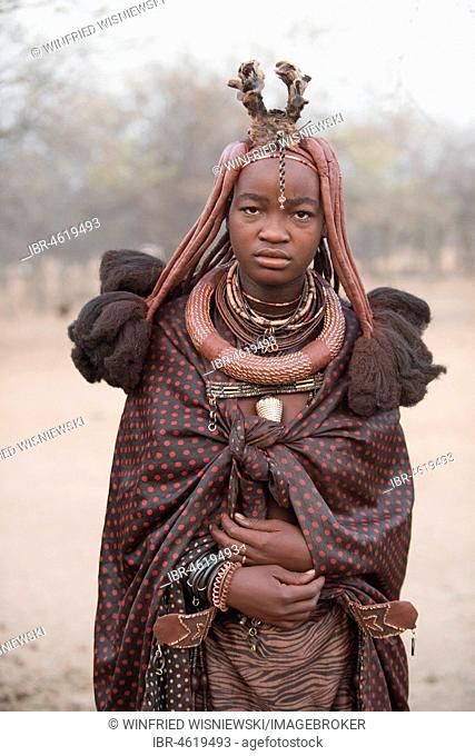 Portrait of a young married woman with blanket, headdress and necklace, Opuwo, Kaokoveld, Namibia