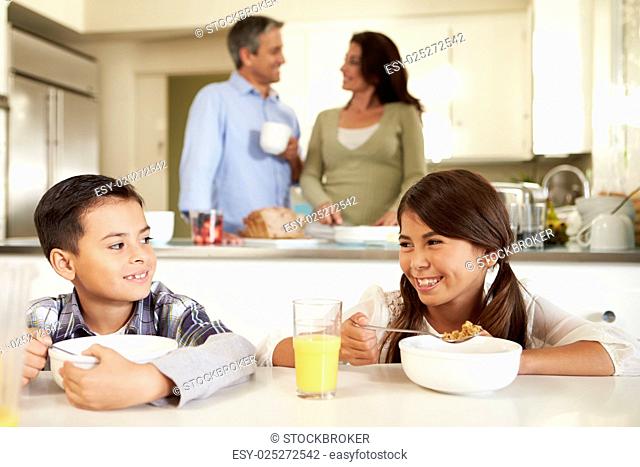 Hispanic Family Eating Breakfast At Home Together