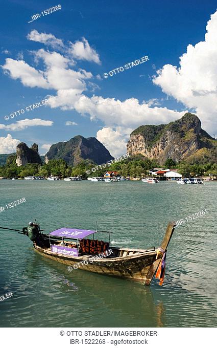 Long-tail boat in Nopparat Thara Bay, limestone rocks, Krabi, Thailand, Asia