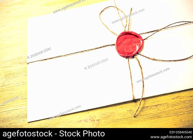 Old letter envelope with wax seal on wooden surface