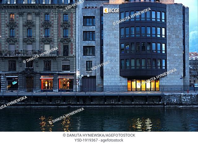 buildings of Geneva at dusk, located on a small island on the Rhone river - I'Ile, BCGE building - Banque Cantonale de Genève and old residential building