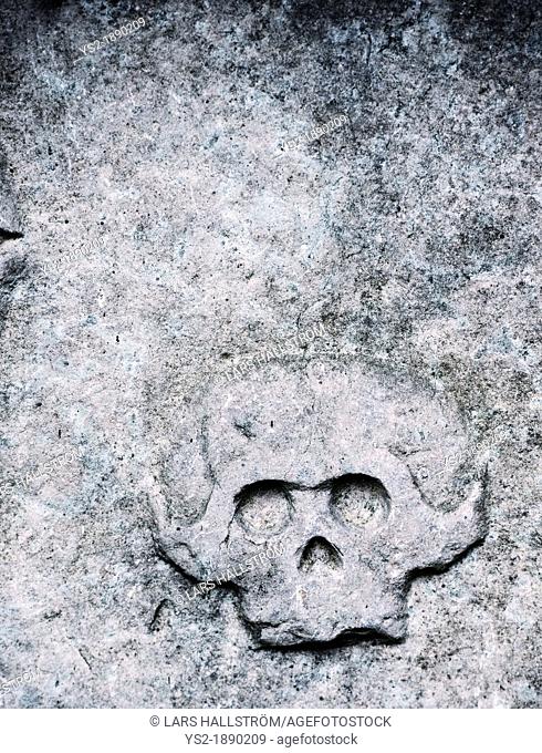 Tombstone with ominous engraving of an old skull